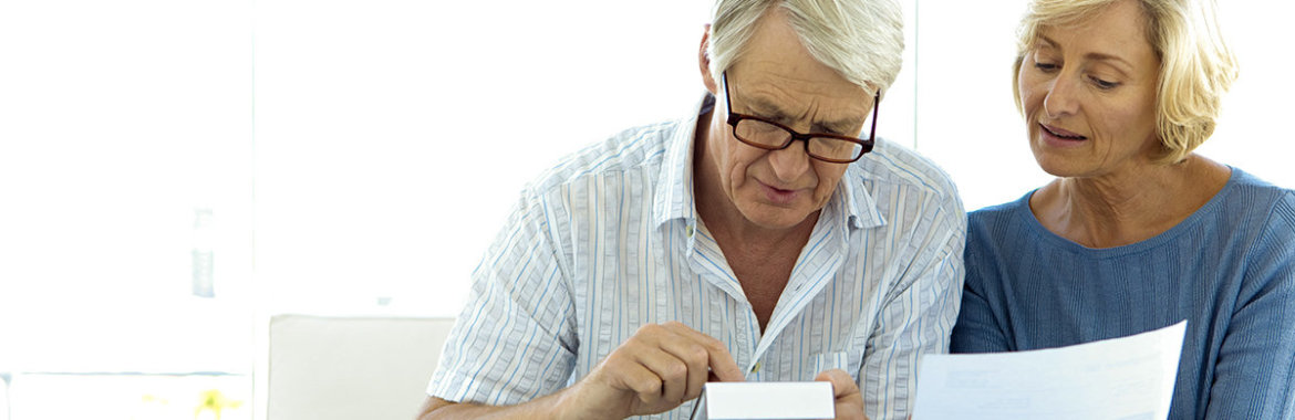 Older couple reviewing Medicare options and costs.