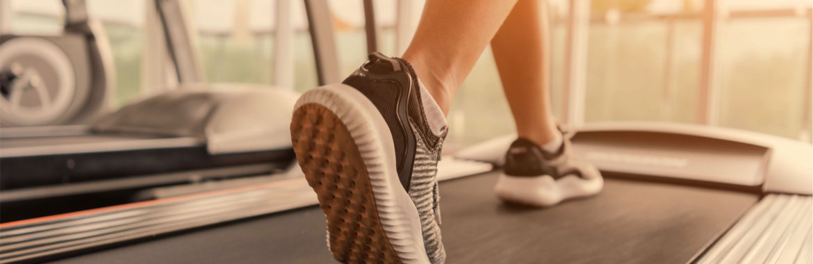 Closeup of woman's shoes as she walks on a treadmill.