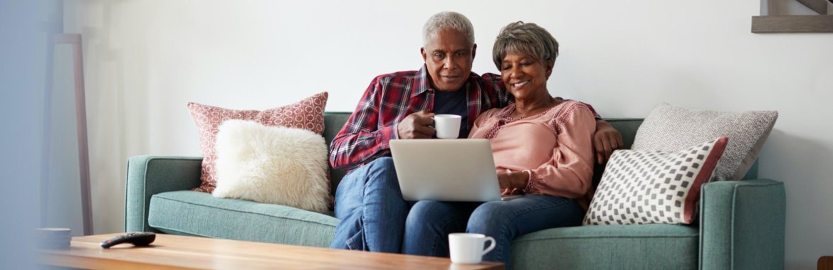 Senior African American couple reviewing Medicare Star Ratings on a laptop computer.