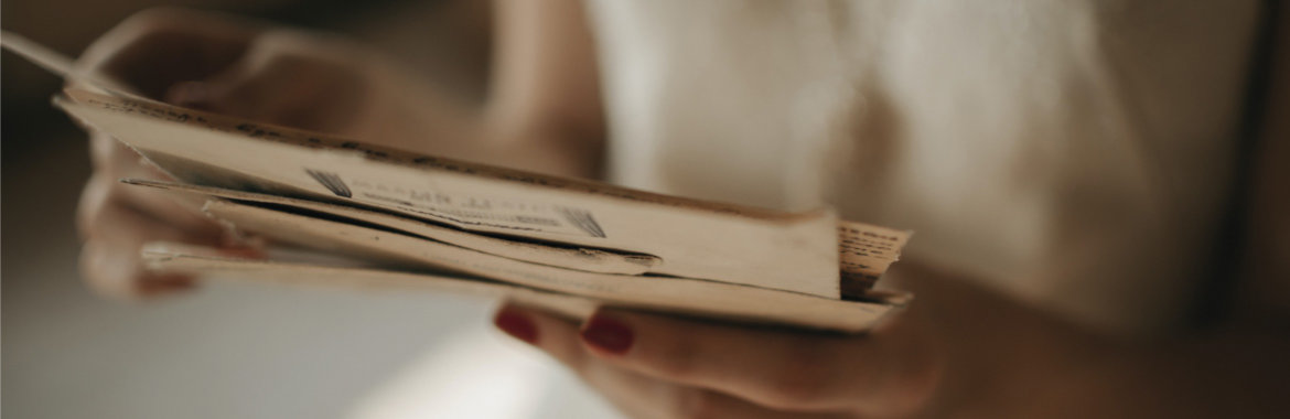 Closeup of woman's hands as she sifts through her mail.