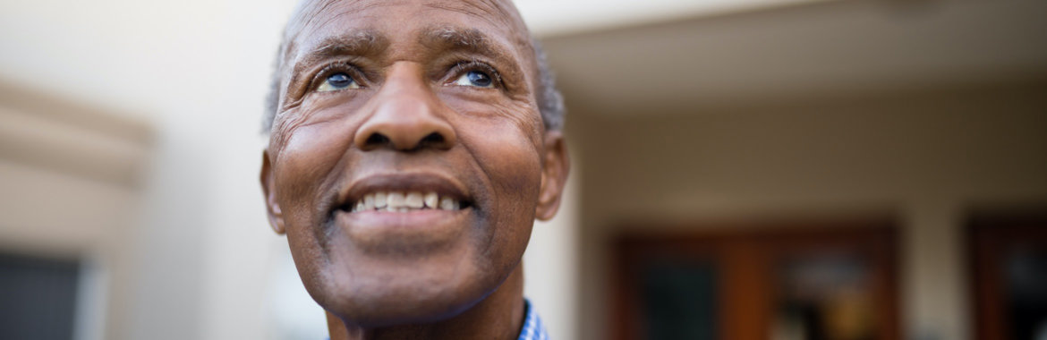 Close up of a smiling elderly African American man.