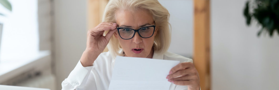 Woman anxiously looks at her healthcare bills.