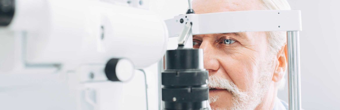 An older adult is tested to see if he needs cataract surgery.