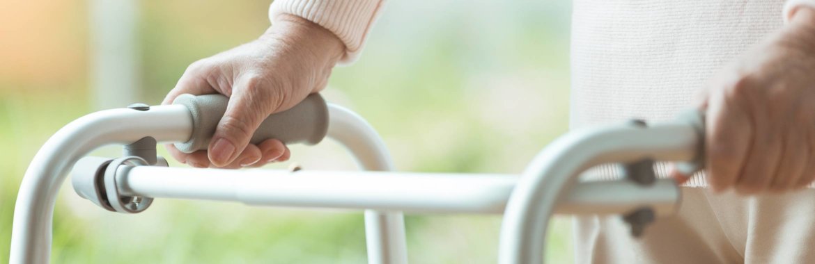 An older adult benefitting from a walker provided by Medicare Part B.