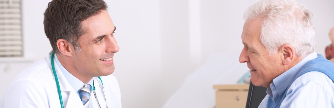 Older adult man speaking with his doctor during a medical visit.