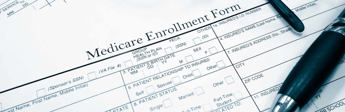 A Medicare enrollment form and a pen.