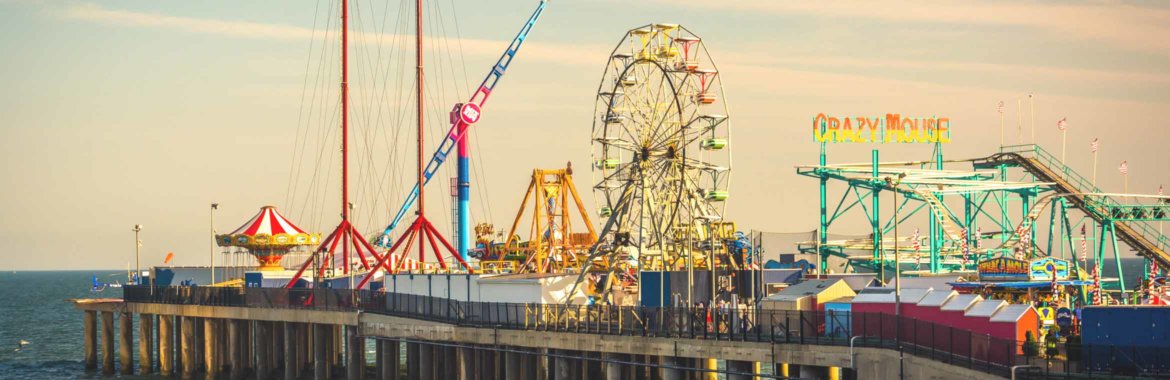 The colorful amusement rides on the Atlantic City Pier at sunset.