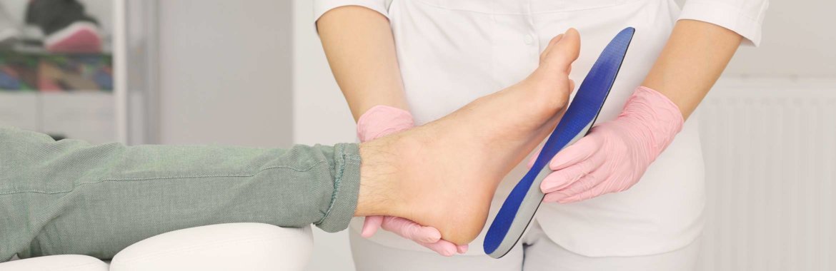 Medicare patient's foot is fitted for an orthotic device.