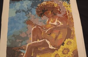 Painting of a girl with a guitar in a pastoral scene.