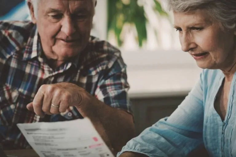 A senior couple looking at a document