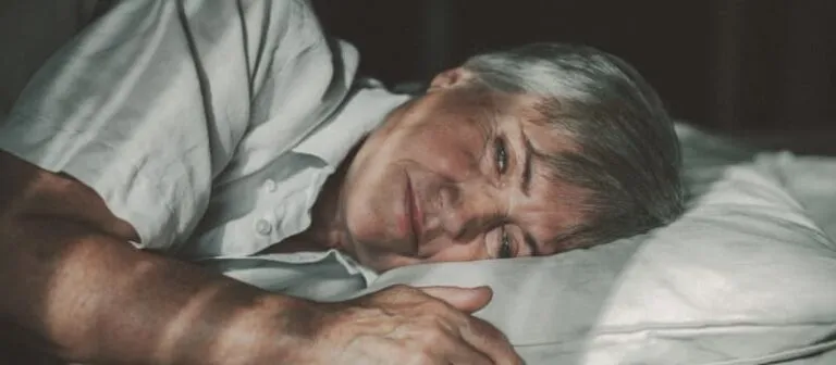 Person sleeping in bed.