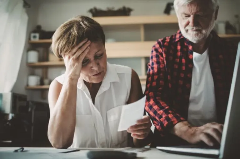 A senior couple looking at a document