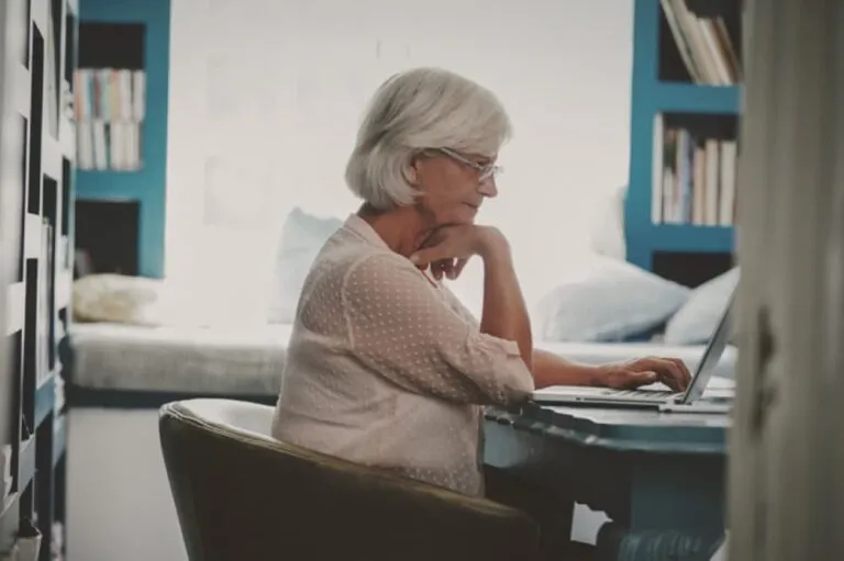 Woman researching at computer.