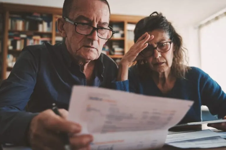A senior couple looking at papers
