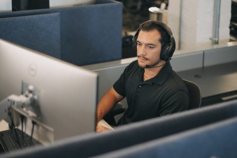 Licensed insurance agent at workstation, wearing headset.