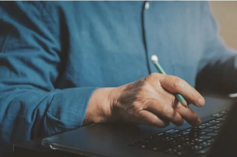 A senior man working on a computer